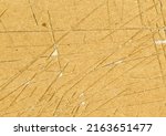 Small photo of Small: Highly detailed close up brown paper board texture with many knife cut marks and scratches worn down, used grunge fine grain layered cardboard with torn surface for wallpaper design