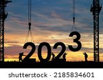 Silhouette of staff works as a team to prepare to welcome the new year 2023