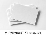 Mockup of business cards fan stack at white textured paper background.