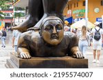Small photo of Medellin, Antioquia, Colombia : July 27 2022 : Botero Plaza. Detail of a sculpture (Man standing over his wife) by Fernando Botero, a famous Colombian artist. Feminist symbol and denunciation.