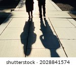 Small photo of Shadows of men and women walking in the precincts