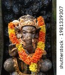 Small photo of Ganesha Statue, Ganesha is one of the most important gods in Hinduism. He is highly recognisable with his elephant head and human body, representing the soul (atman) and the physical (maya).