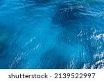 Seawater background. Blue sea with little waves texture. The unique color of the water. Seawater surface texture.