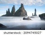 Small photo of Long exposure of the coast of Vik. Fish-shaped rock formation in the sea close to the black volcanic beach of Iceland. Icelandic nature.