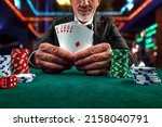 Gambling concept. Close up of Poker Player male hand Winning Royal Flush at casino, gambling club. Сasino chips or Casino tokens,  dice, poker cards, gambling man lucky guy, games of chance.