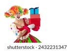 Small photo of Funny female clown with gifts. Entertainer woman Joker in colorful suit and wig. Buffoon with clown whiteface makeup. Trickster, jester, pantomime, mime. Professional actor