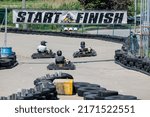 Small photo of Saint-Zotique, Canada - June 25, 2022: Go kart riders race around an outdoor track and jockey for position