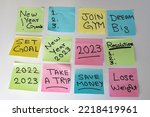 New Year 2023 goals hand written on a sticky notes on a white isolated background