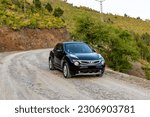 Small photo of Nissan Juke impul black model driving on a mountain road: Swat, Pakistan - May 19 2023