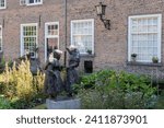 Small photo of Breda, Netherlands, September 15, 2023; Bronze work of art 'Two beguines in conversation', by Hans Bayens at the beguinage in Breda.