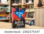 Small photo of Setif, Algeria - May 08, 2023: Close up Joseph Elliott's The Broken Raven book in the bookshop. Fantasy Fiction.