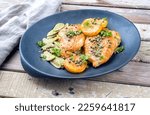 Small photo of Modern style traditional Italian deep-fried chicken piccata with capper and pasta offered as close-up in a design plate with copy space