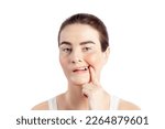 Small photo of Woman shows a broken tooth. Absence of a tooth. She needs an implant, close up photo white background