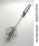 Small photo of Modern egg beater stainless steel. Use your hand to press down on the handle, then the beater head will spin.