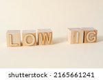 LOW IG sign on wooden cubes on the light beige background