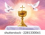 Small photo of Chalice with crucifix in an altar with flying doves. Holy eucharist theme concept.