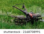 A Small Red Manual Hand Tractor ...