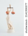 Small photo of Lady Justice holds scales with heart and human brain on isolated white background. Balance between emotions and rationality. Critical concept of law. Mental health, wellness or making good decisions.