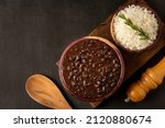 Small photo of Black beans and rice in wooden bowl.