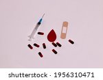 Small photo of Background of World Hemophilia Day. A poster of awareness about hemophilia. Red drops, a syringe, medications. World Hemophilia Day on a white background.