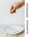 Small photo of Seed of garden cress spread on white plate with wet paper towel in front of white background