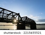 Sunrise glows through Tauranga Railway bridge silhouette