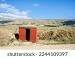 Small photo of Middlemarch New Zealand - March 3 2010; Small red corrugated iron Moynihans Hut with Rock and Pillar Range behind