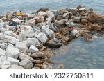 Small photo of Riomaggiore Italy - April 26 2011; Young adult tourists sunning and relaxing on pock pier in bay