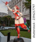 Small photo of Cannes, French Riviera., France - May 2 2011; Public art sculpture of scantily clad woman standing on one leg reaching upwards with bird in hand outdoors in famous city of Cannes