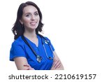 Small photo of Smiling Winsome Professional Female GP Doctor Posing in Blue Doctor's Smock with Endoscope And Hands Folded On White Background. Horizontal Image Composition