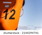 Orange Lifeboat On Side Of...