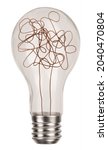 Small photo of Classic incandescent light bulb with chaotic wire isolated on white background. Mind concept with symbol of complicated thinking and idea photo