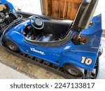 Small photo of Callicoon, NY, USA, 10.11.22 - Go Karts that are parked in separate lanes. A blue gokart says the number 10 and brand Kleenex on it.