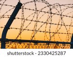 Sunset sky and barbed wire