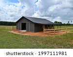 Horse barn built with post frame materials; two lean-to