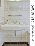 Small photo of White bathroom with simple unassuming tiles in white style
