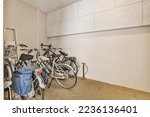 two bikes parked in a room with no one bike on the floor and another standing next to each other bicycles