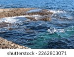 sea waves hitting the rocks on the shore