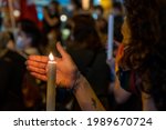 Small photo of Madrid, Spain. June 11, 2021. Woman holding and lighting candles at the rally of the feminist movement in repudiation of all femicides Sol square in Madrid.