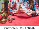 Small photo of Close-up of unrecognizable Caucasian female hands mixing and shuffling tarot cards to begin therapeutic reading. copy space.