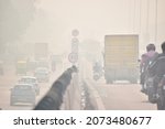 Small photo of People pass through the rising pollution on the Delhi-Jaipur Expressway. Gurgaon, Haryana, India. november 12, 2021.
