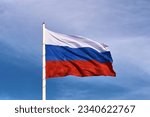Small photo of Large flag of the Russian Federation on a flagpole 75 meters high. Technological device with wind speed sensors and automatic flag height adjustment system. Blagoveshchensk, Far East, Russia. Close up