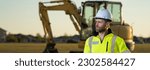 Small photo of Portrait of worker man small business owner. Construction worker with hardhat helmet on construction site. Construction engineer worker in builder uniform with excavation truck digging. Worker