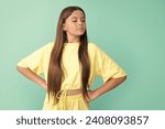 Small photo of arrogant kid with long hair on blue background with copy space, arrogance