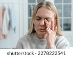 closeup of blonde female feel eye strain or migraine, exhausted young woman worker with headache pain, bad weak blurry vision, eyesight problem