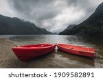 Red Boats Ashore A Fjord  