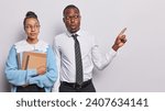 Small photo of Education concept. Headmaster and headteacher of school stand closely to each other advertise their private school carry notepads dressed in smart clothing isolated over white background copy space