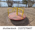 Small photo of A child's playground with the view of a merry go round.