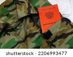 Small photo of Military uniform and military ID of a citizen of the Russian Federation. Translation: "Military ID"