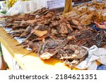 Small photo of Smoked and grilled stingrays skewered on bamboo sticks sold in traditional markets are ready to eat. Pari fish. Batoidea is a superorder of cartilaginous fishes, commonly known as rays.